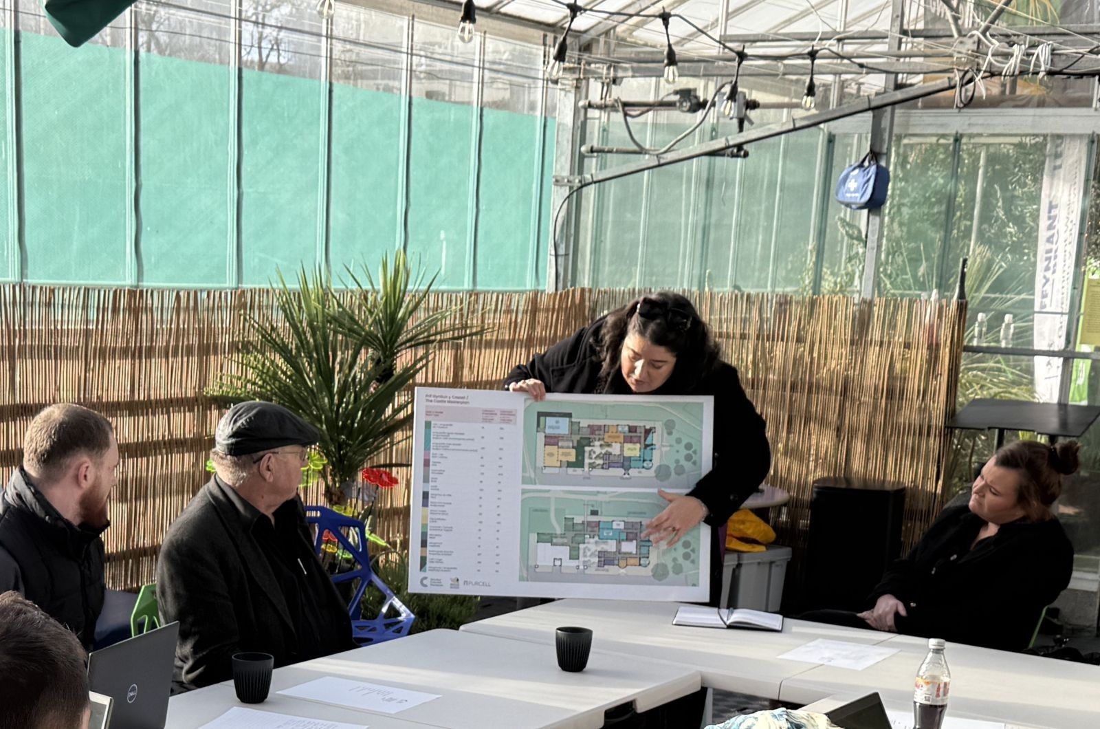CEO of the Cyfarthfa Foundation presenting plans of the castle to people sat around a table..JPG